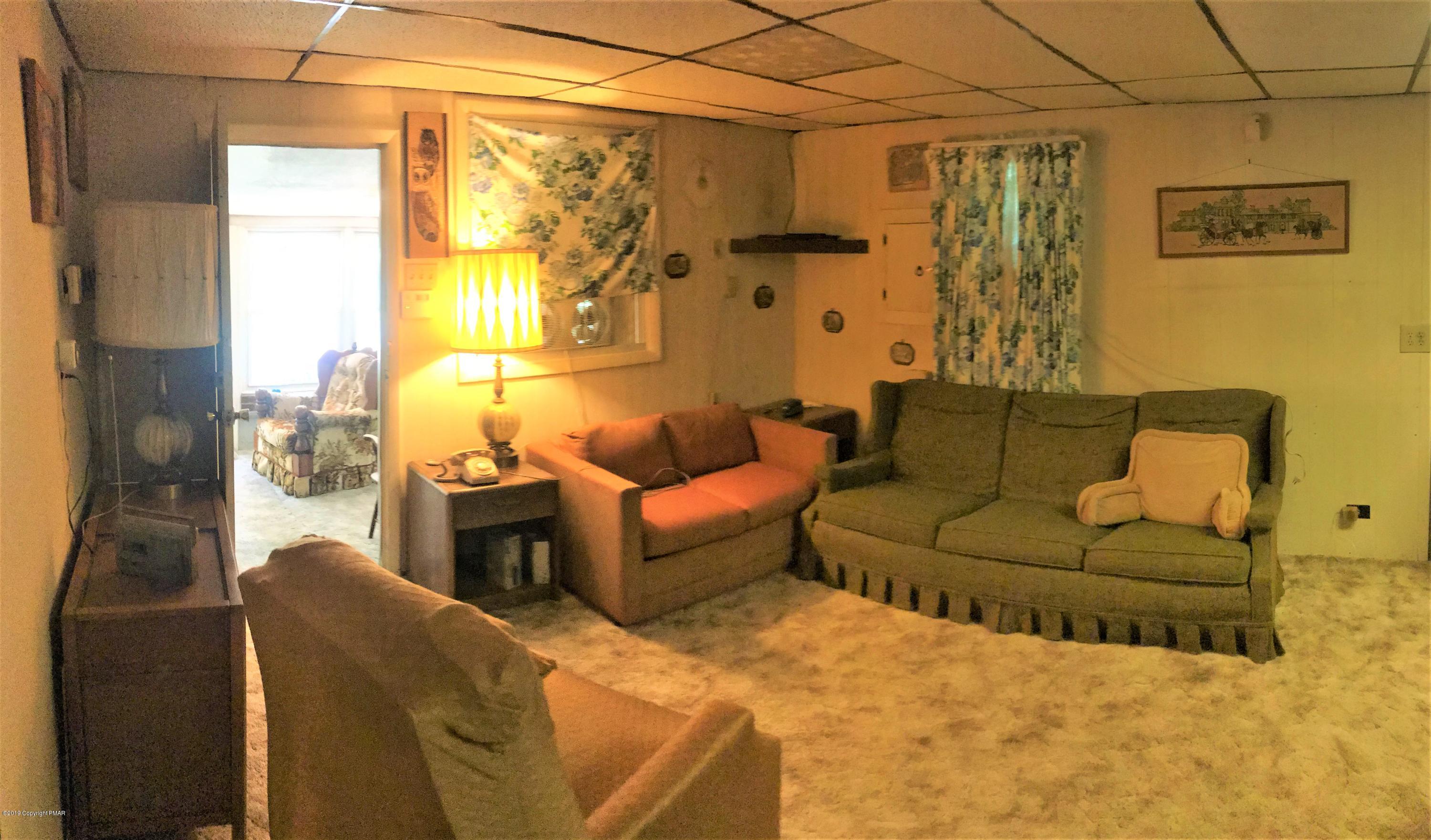 820 Westbrook Road Effort, PA 18330 - Photo 8 of 13 a living room with furniture and a flat screen tv