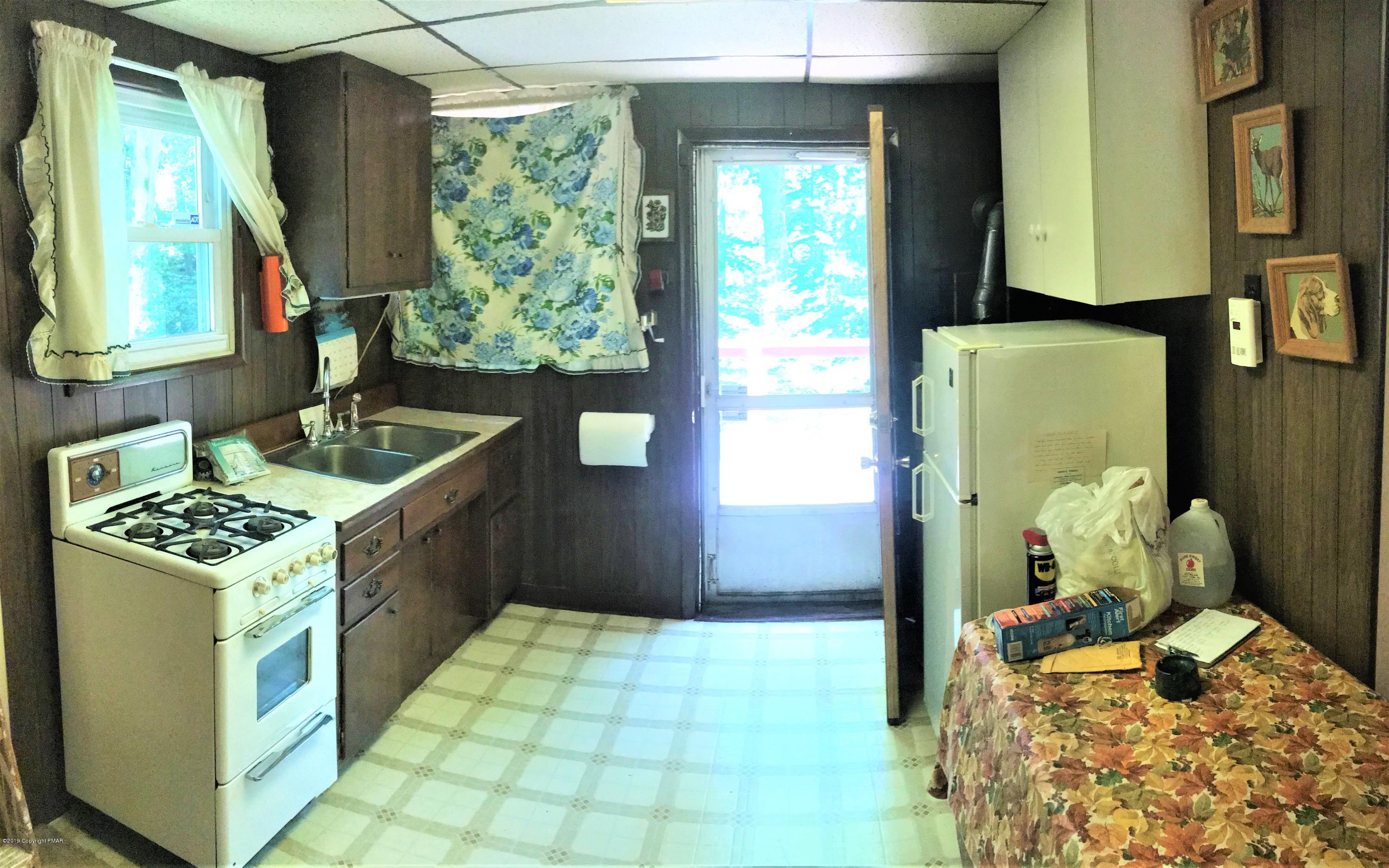 820 Westbrook Road Effort, PA 18330 - Photo 9 of 13 a kitchen with a stove a refrigerator and a stove