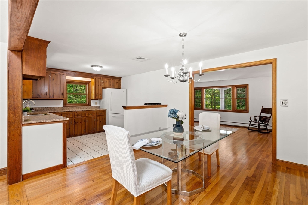 371 Longley Road Groton, MA 01450 - Photo 9 of 33 a view of a dining room with furniture a chandelier and wooden floor