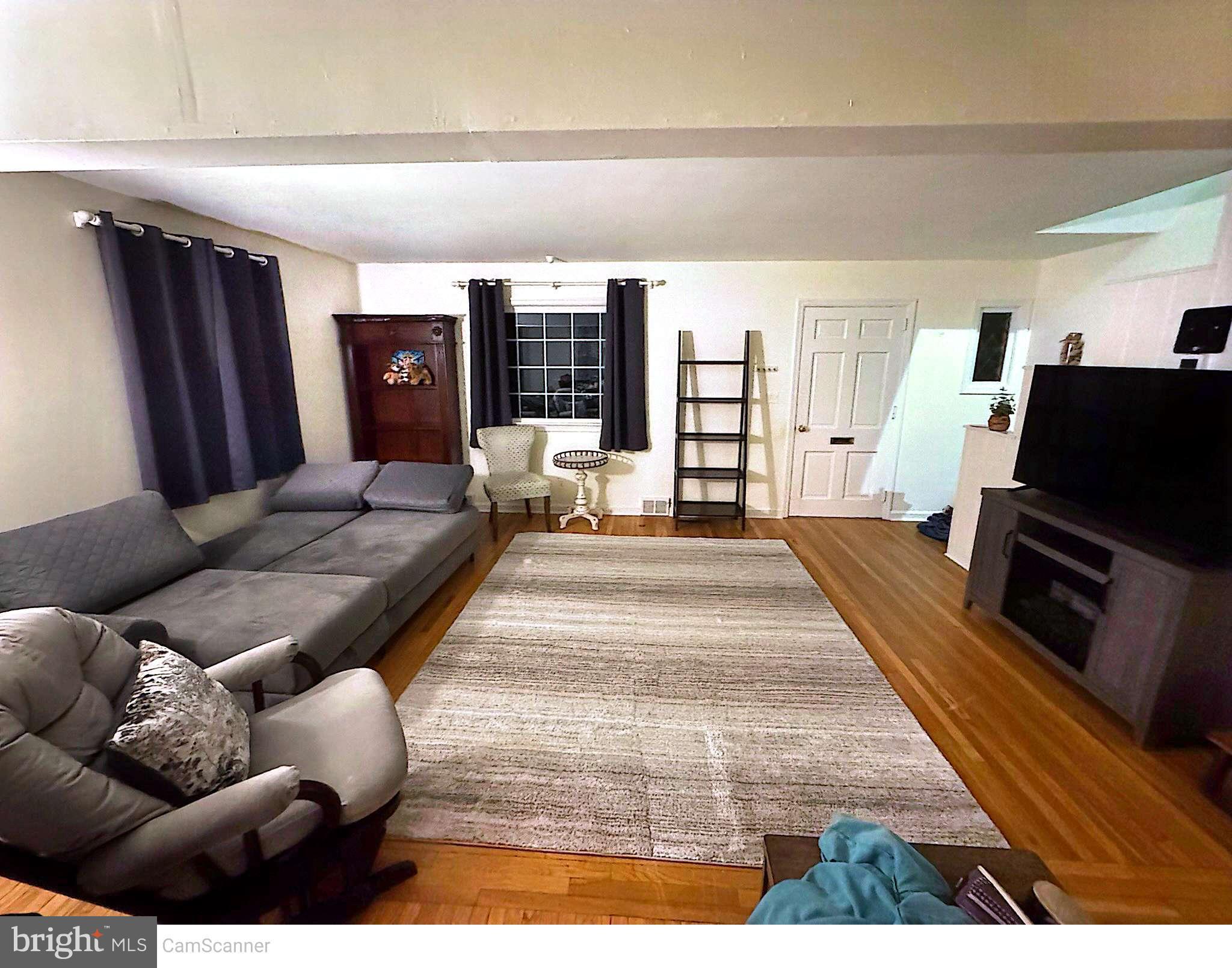 409 Swarthmore Road Glassboro, NJ 08028 - Photo 12 of 14 a living room with furniture and a flat screen tv