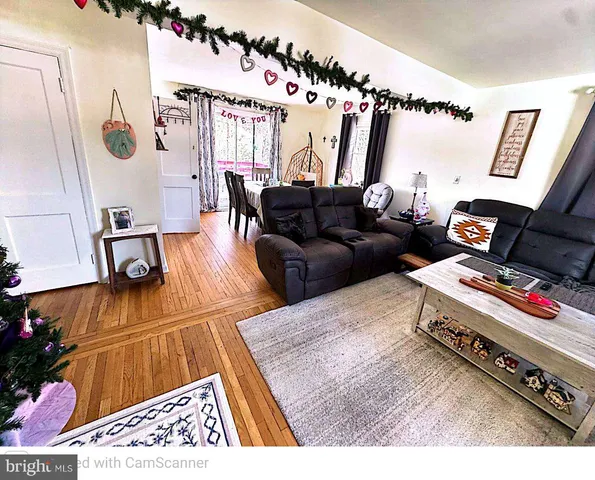 a bedroom with a bed a rug and dresser