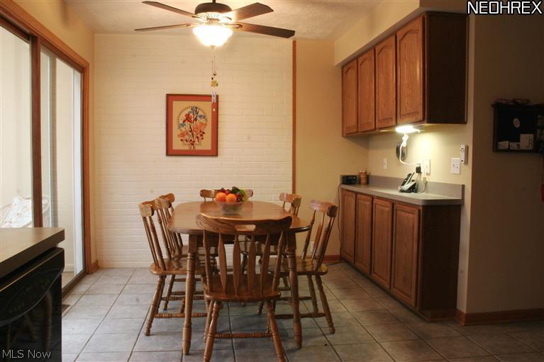 2900 Medfield Road Cleveland, OH 44124 - Photo 7 of 25 Kitchen eat-in area with sliders to 3-season porch, offering more dining options.
