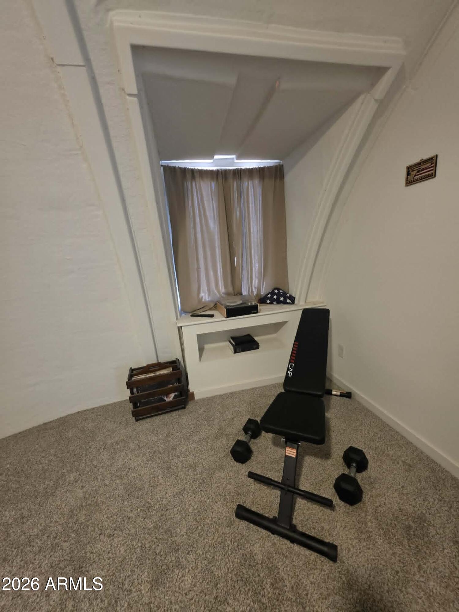 1523 South Warren Road Maricopa, AZ 85139 - Photo 16 of 26 a room with gym equipment and wooden floor