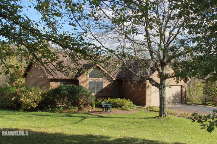 122 North Brodrecht Road Galena, IL 61036 - Photo 1 of 23 a front view of a house with a garden and trees