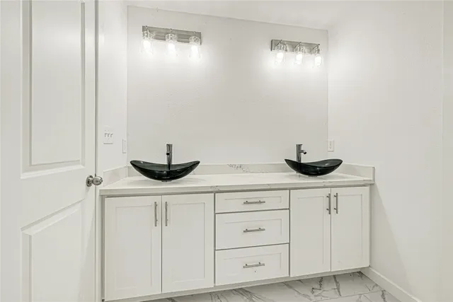 a kitchen with white cabinets