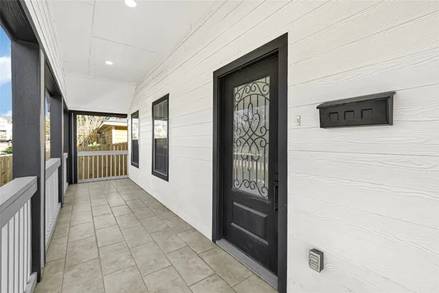 a view of a hallway with wooden floor and windows