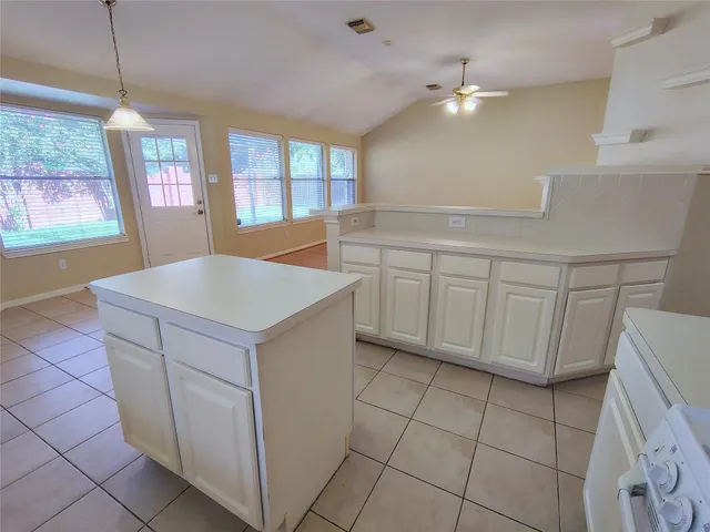 a kitchen with cabinets and window