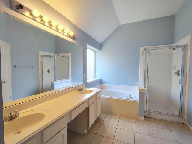 a bathroom with a tub sink and a mirror