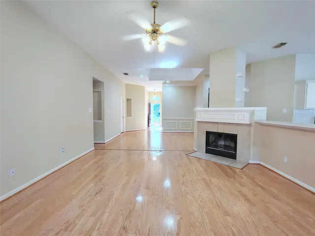 a view of an empty room with a fireplace and a window