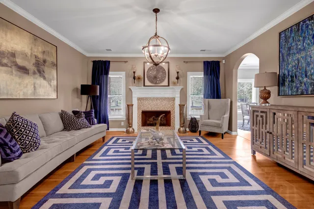 a living room with furniture and a chandelier