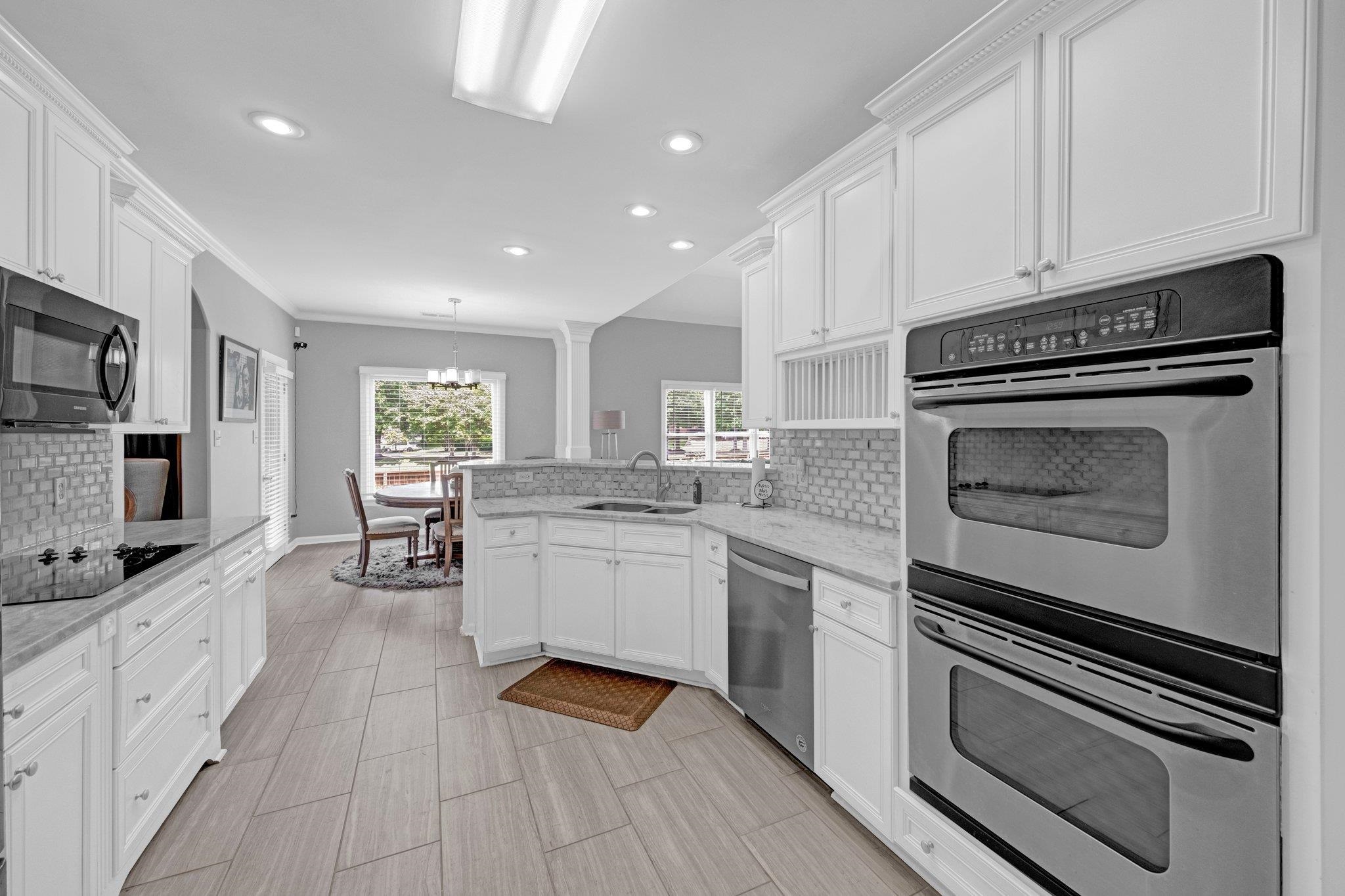 546 Township Cove Collierville, TN 38017 - Photo 11 of 40 a kitchen with granite countertop cabinets stainless steel appliances and a counter space