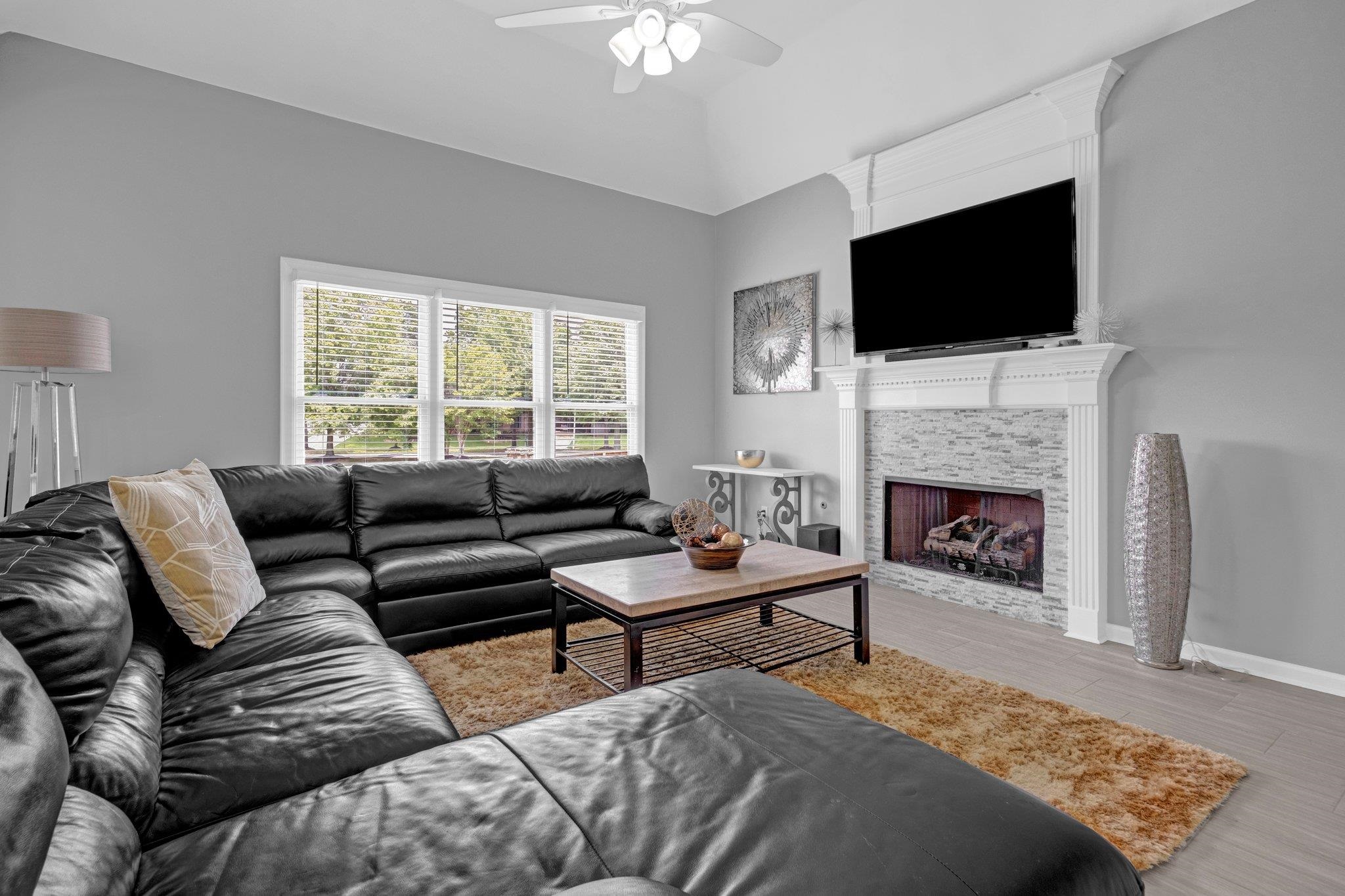 546 Township Cove Collierville, TN 38017 - Photo 14 of 40 a living room with furniture a fireplace and a flat screen tv