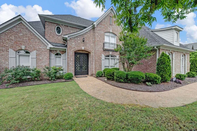 a front view of a house with a garden