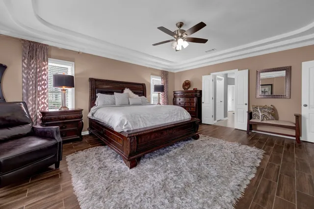 a bedroom with a bed and a chandelier