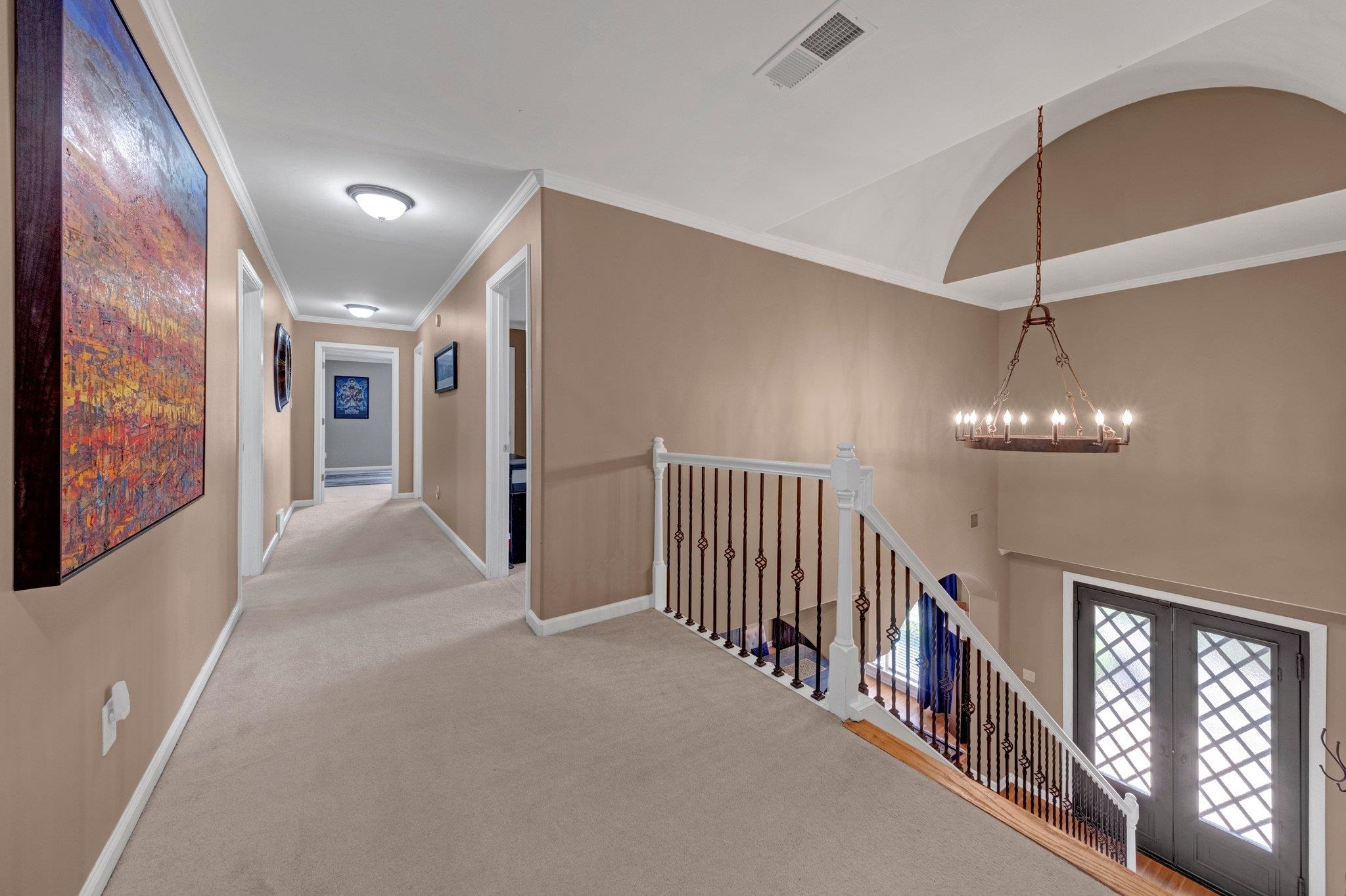 546 Township Cove Collierville, TN 38017 - Photo 26 of 40 a view of a hallway with windows and chandelier