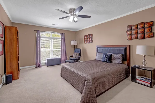 a view of a hallway with windows and chandelier