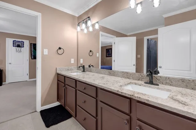 a spacious bedroom with a bed and a chandelier