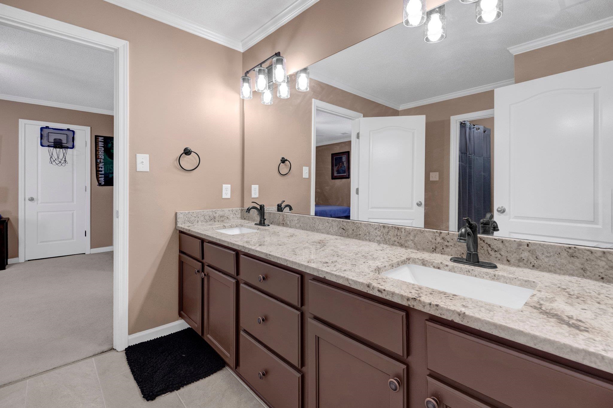 546 Township Cove Collierville, TN 38017 - Photo 31 of 40 a bathroom with double vanity sinks and a mirror