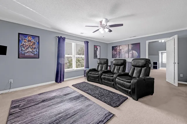 a spacious bedroom with a bed and a chandelier