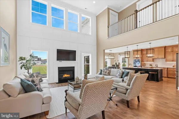 a living room with furniture and kitchen view