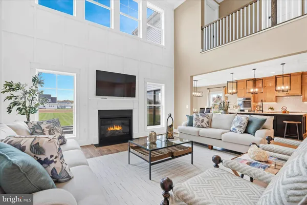 a kitchen with stainless steel appliances a kitchen island hardwood floor sink stove and wooden cabinets