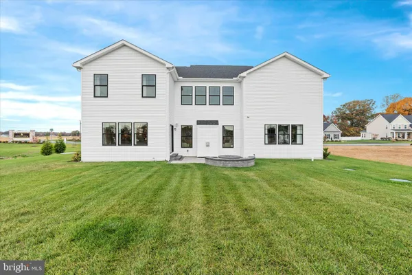 a view of a house with a yard and sitting area