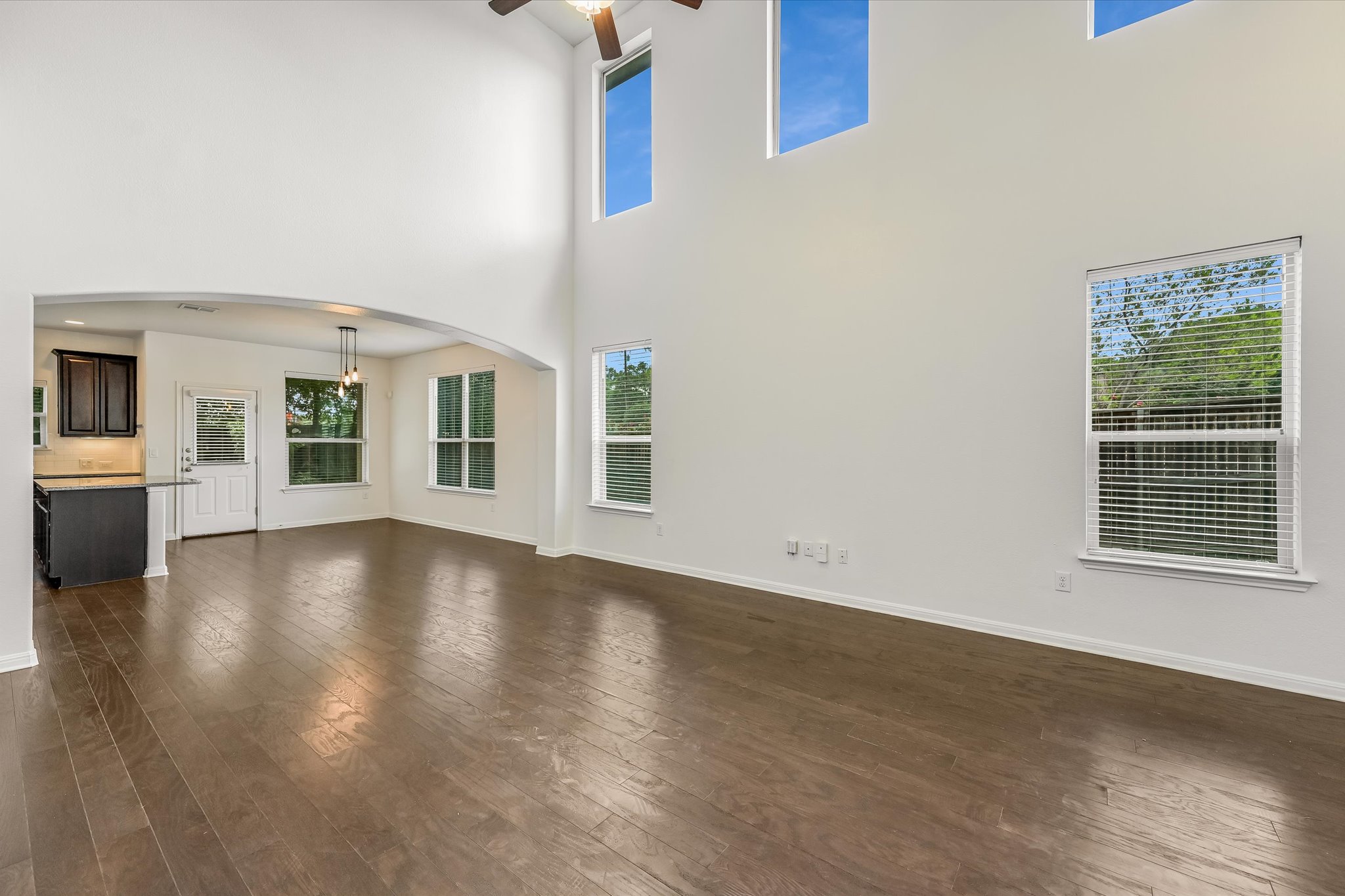 7709 Menchaca Road, Unit 1 Austin, TX 78745 - Photo 5 of 29 Soaring two story living room expands the already spacious room and the wall of windows floods the space with natural light.