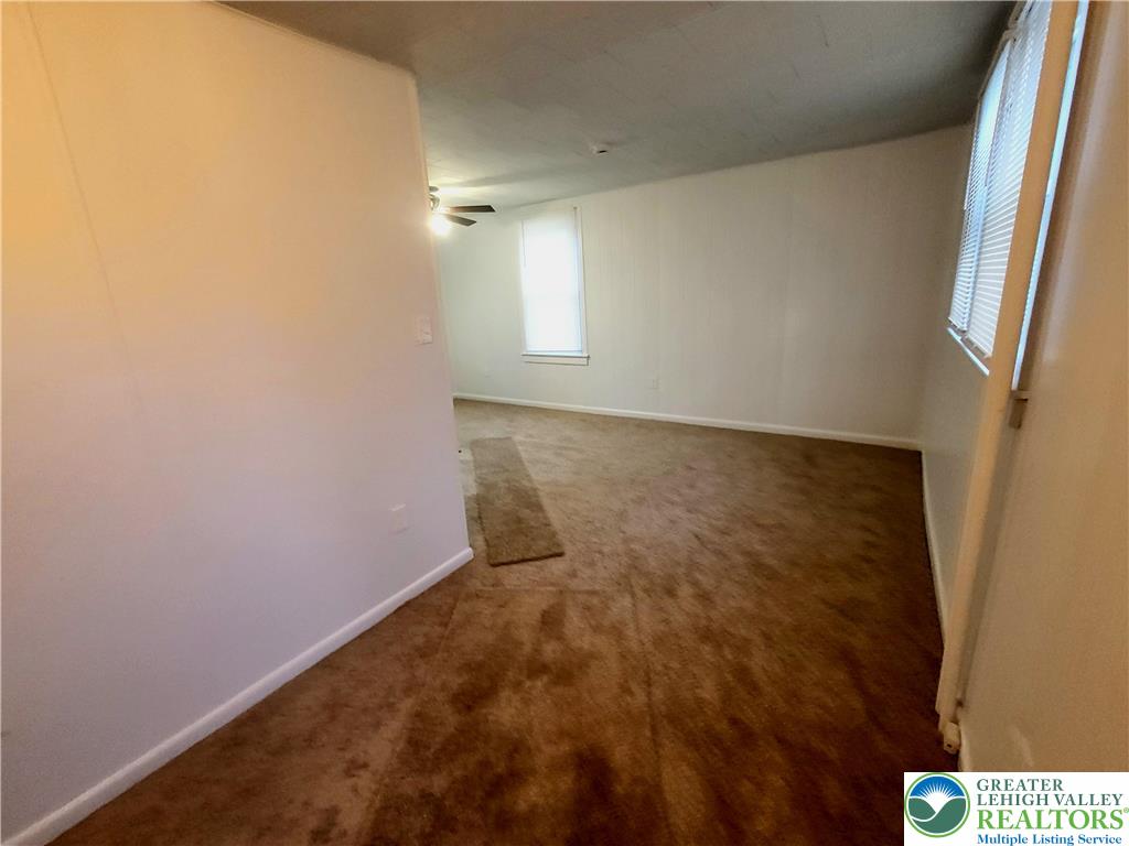 817 Seneca Street, Unit B Fountain Hill, PA 18015 - Photo 4 of 12 an empty room with windows