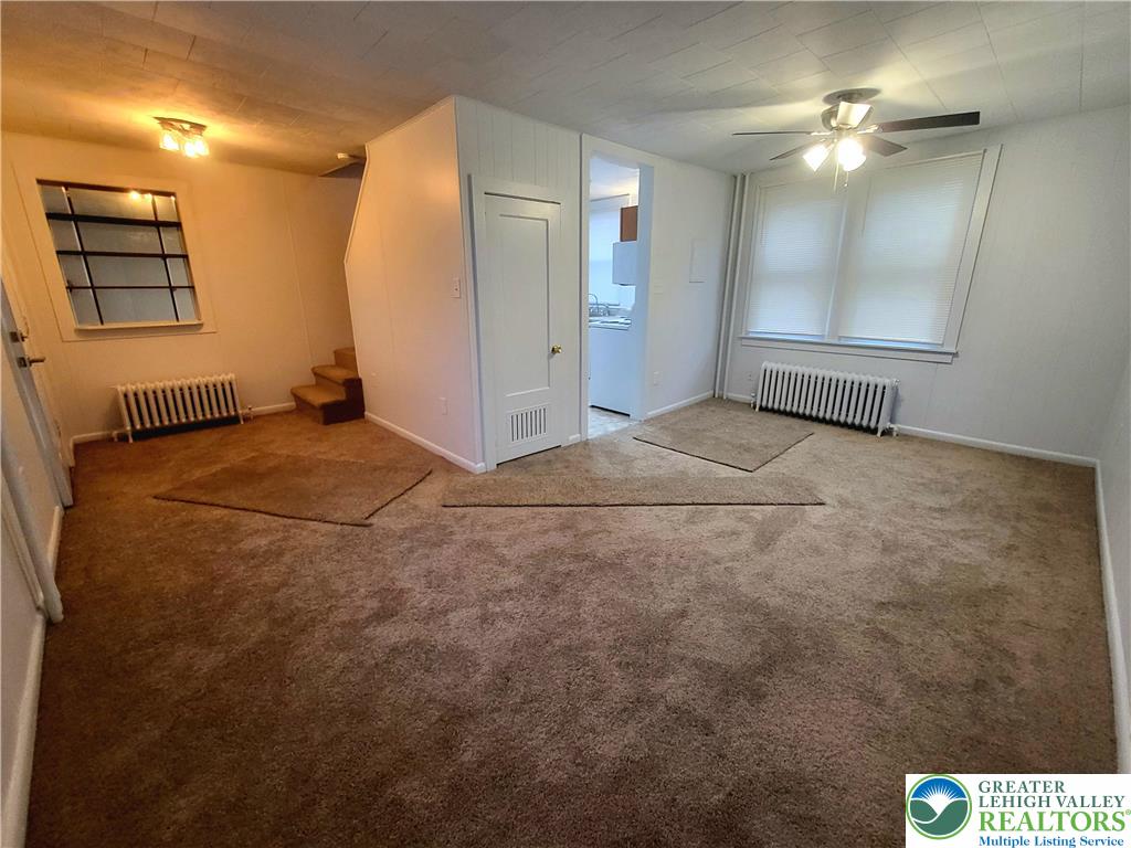 817 Seneca Street, Unit B Fountain Hill, PA 18015 - Photo 5 of 12 an empty room with windows and fan
