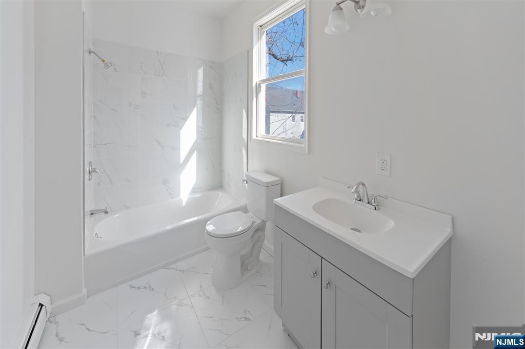 118 Ray Street, Unit 2 Garfield, NJ 07026 - Photo 11 of 15 a bathroom with a sink toilet and shower