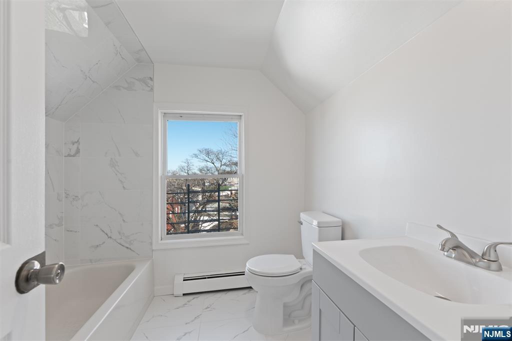 118 Ray Street, Unit 2 Garfield, NJ 07026 - Photo 14 of 15 a bathroom with a sink toilet and shower