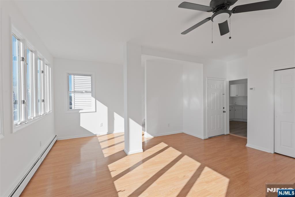 118 Ray Street, Unit 2 Garfield, NJ 07026 - Photo 4 of 15 a bedroom with a bed and wooden floor