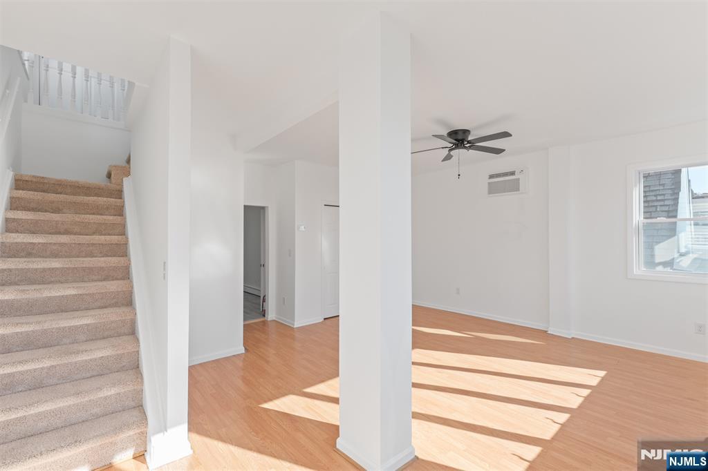 118 Ray Street, Unit 2 Garfield, NJ 07026 - Photo 5 of 15 a view of a hallway with wooden floor and staircase