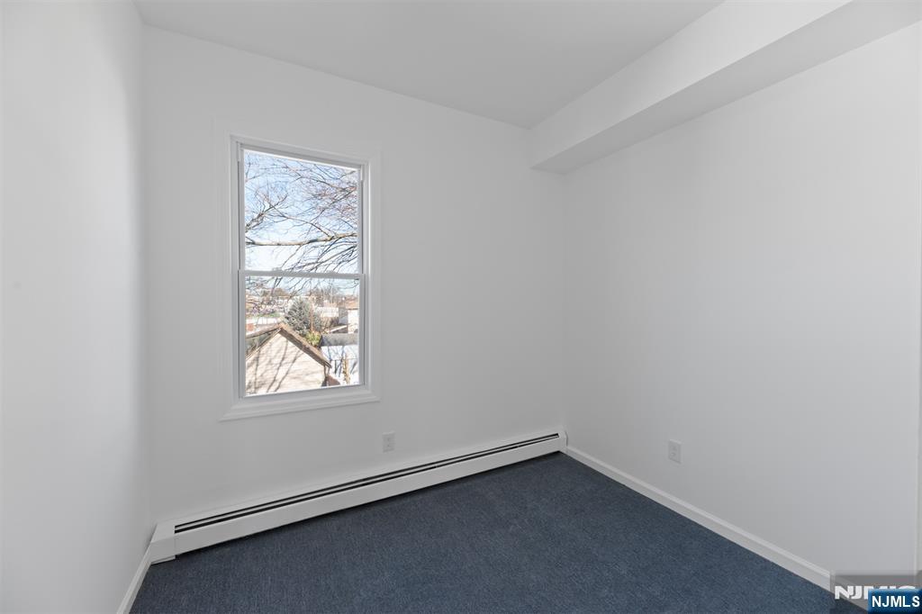 118 Ray Street, Unit 2 Garfield, NJ 07026 - Photo 9 of 15 an empty room with windows