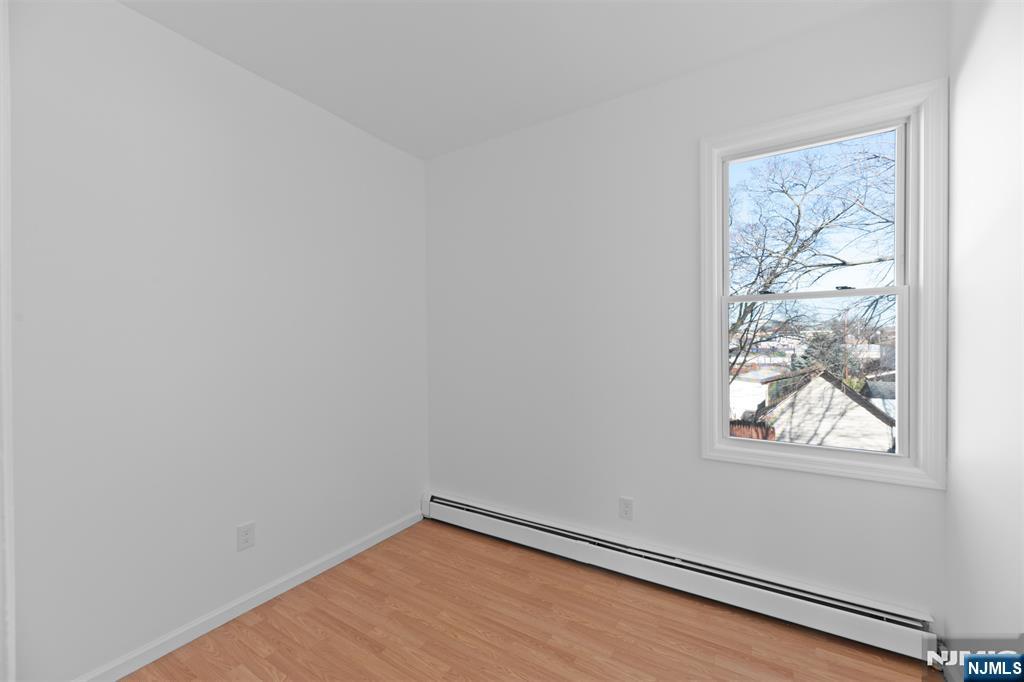 118 Ray Street, Unit 2 Garfield, NJ 07026 - Photo 10 of 15 a view of a small space with wooden floor and a window