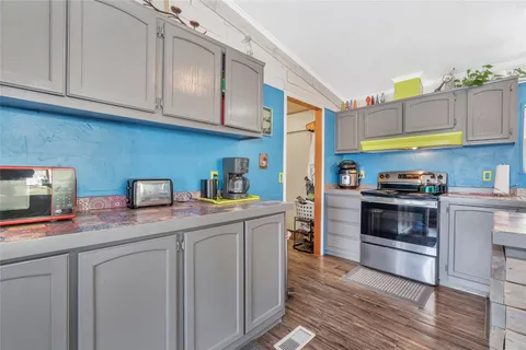 a kitchen with stainless steel appliances granite countertop a sink and cabinets