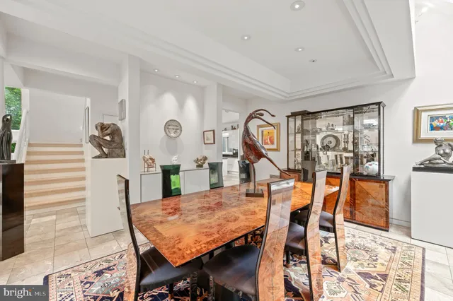 a dining room with furniture water view and balcony