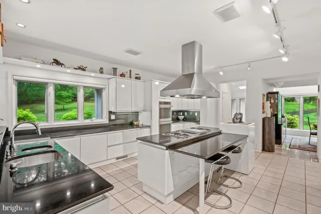 a view of a deck with two chairs and wooden floor