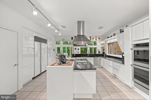 a living room with furniture large window and a fireplace