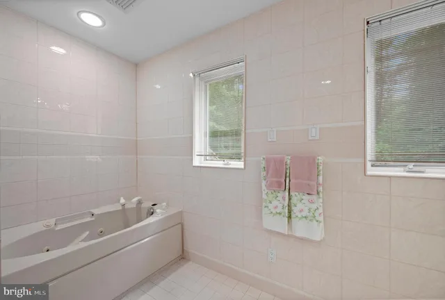 a room with lots of tables a large window and furniture