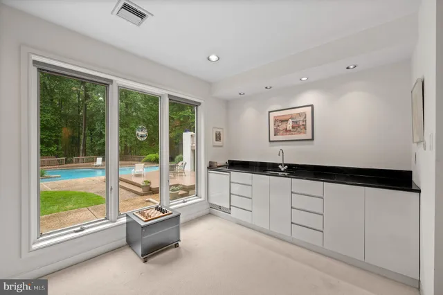 a front view of a house with a garden and trees