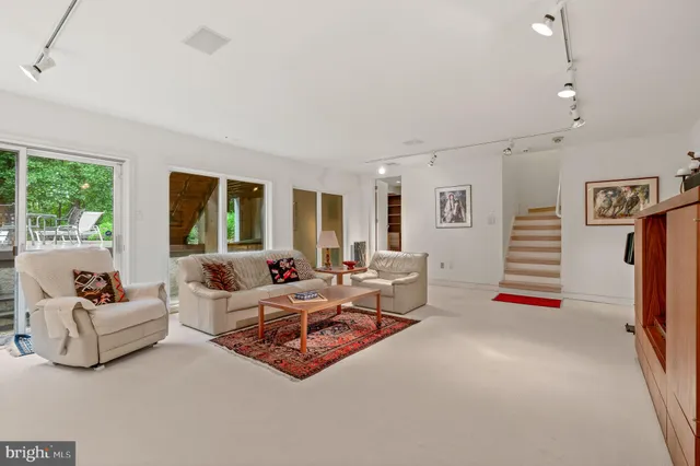 an aerial view of a house with a yard basket ball court and outdoor seating