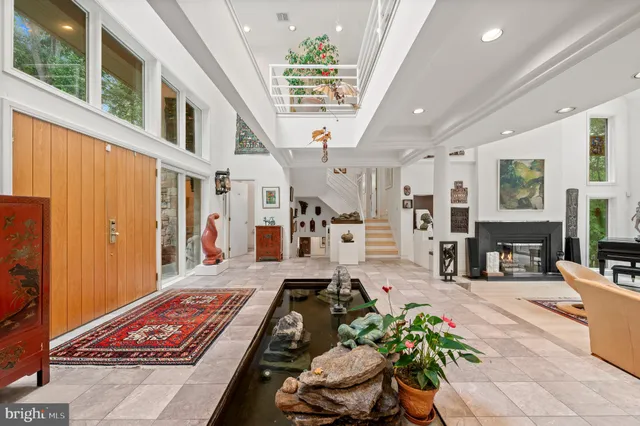a kitchen with stainless steel appliances kitchen island granite countertop a stove and a sink with cabinets