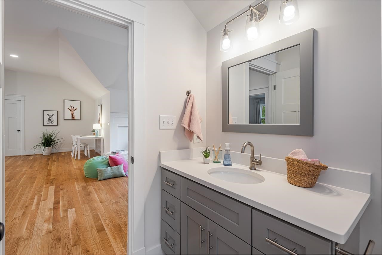 601 Jerome Road Durham, NC 27713 - Photo 41 of 52 a en suite bathroom with a granite countertop sink and a mirror