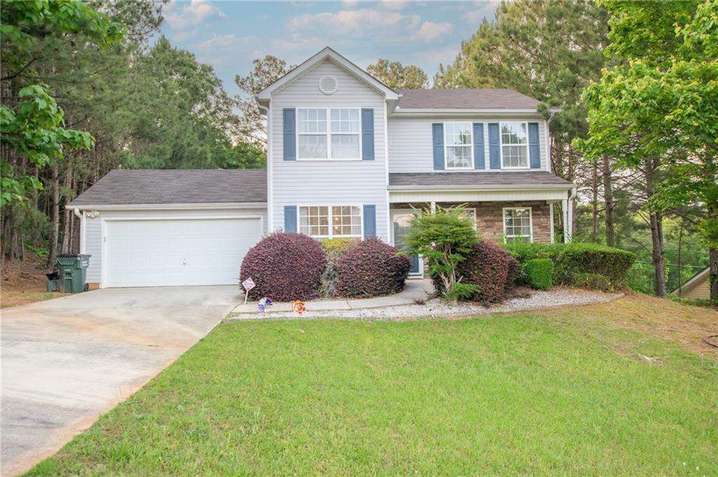 4331 Raptor Place Snellville, GA 30039 - Photo 1 of 1 a front view of a house with a yard and garage