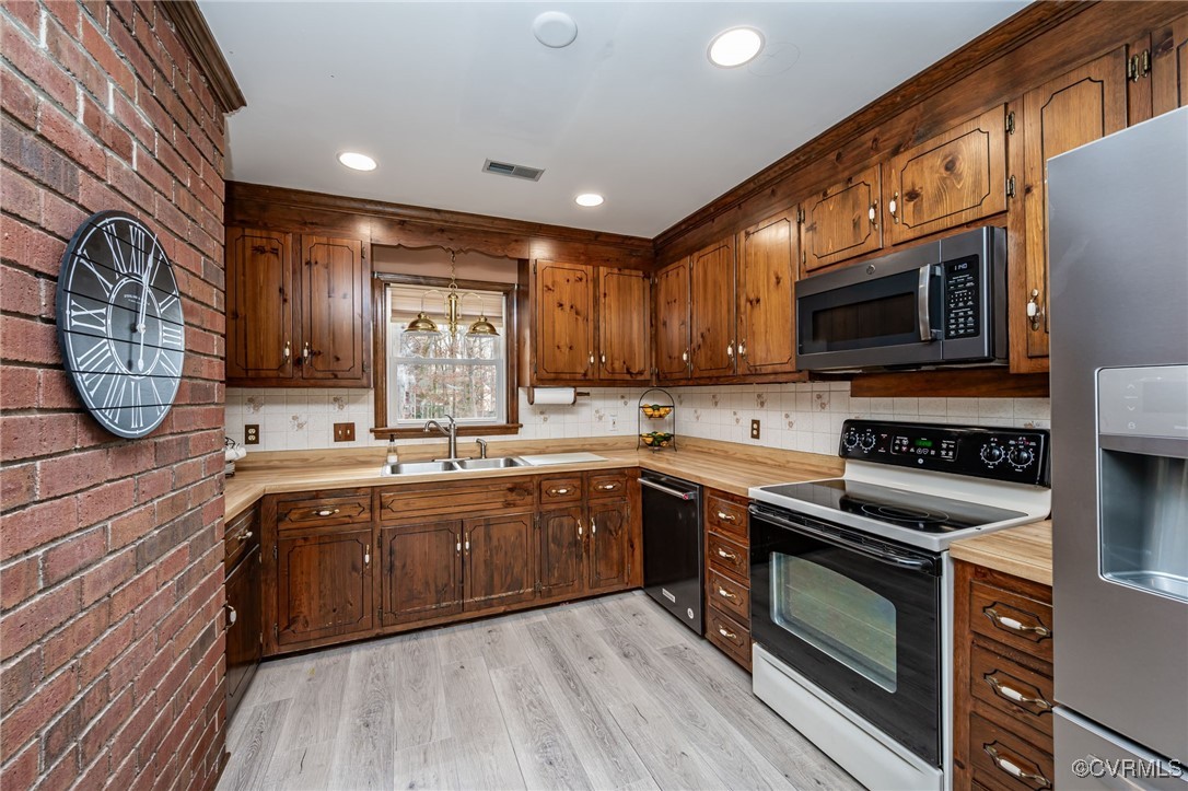 4724 Brookridge Road Chesterfield, VA 23832 - Photo 5 of 23 Kitchen featuring brick wall, stainless steel appl