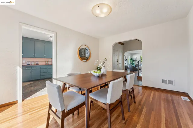 a kitchen with a table chairs sink and cabinets