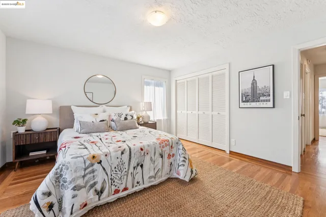 a bedroom with a bed table and dresser
