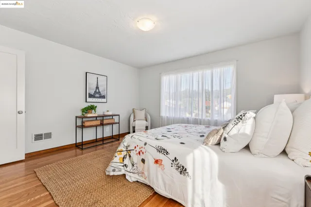 a bedroom with a bed and a potted plant