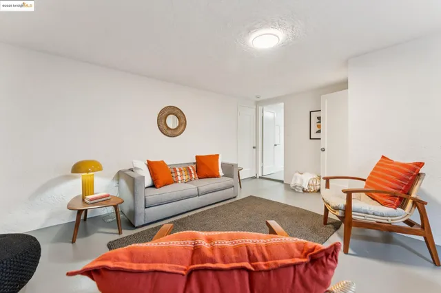a view of a house with a yard and large tree